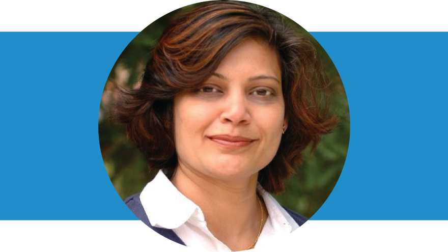 Garima Srivastava has dark short wavy hair. She's wearing a white color shirt.