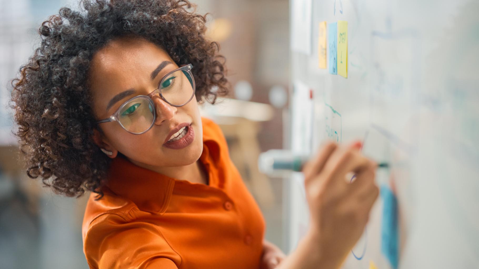 Woman writing on a whiteboard