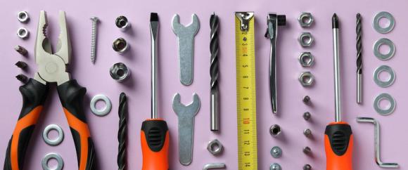 Work tools on purple background, top view